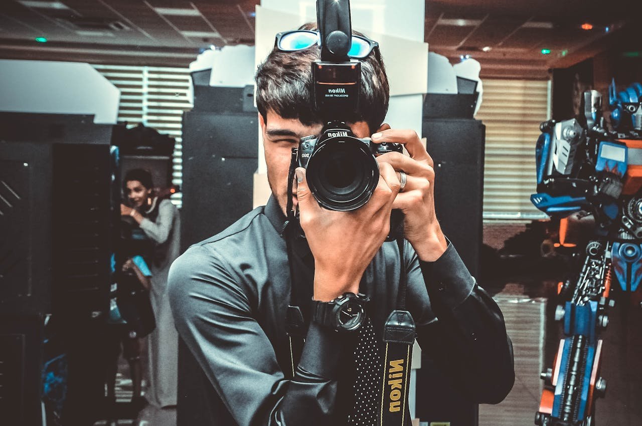 Man taking a picture with a DSLR camera indoors. Professional photography setup.